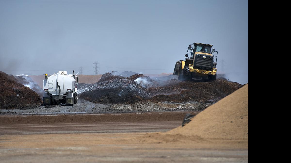
Crews work to contain a fire at a compost facility on South Tracy Boulevard in Tracy on Wednesday.
