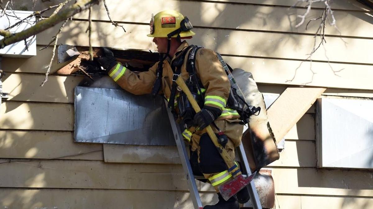 A California Department of Forestry and Fire Protection firefighter from Merced County works to put out a fire inside an abandoned building at the Castle Commerce Center on Wednesday, June 1, 2016.