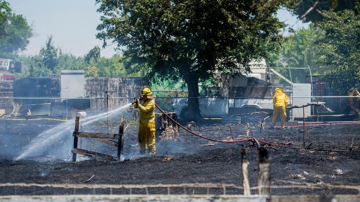 State and Merced County fire crews tackle a blaze Wednesday, June 1, 2016, that burned the front yards of multiple homes as it damaged two sheds and two cars in the 4400 block of Buhach Road in Atwater.