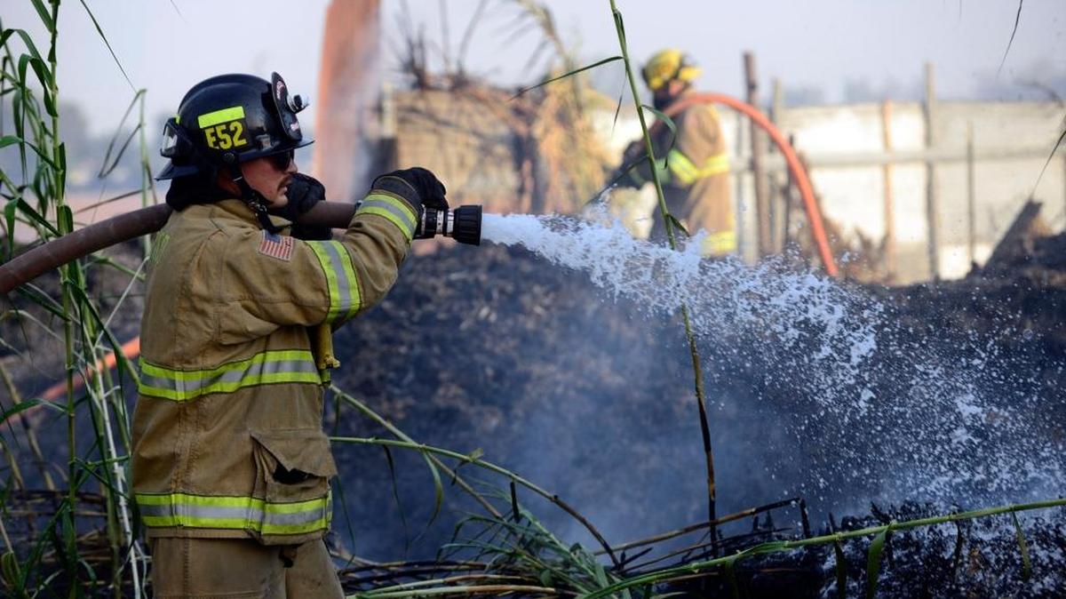 
Merced Fire Department firefighters put down flames burning vegetation in September  at Winder and Barroso avenues.
