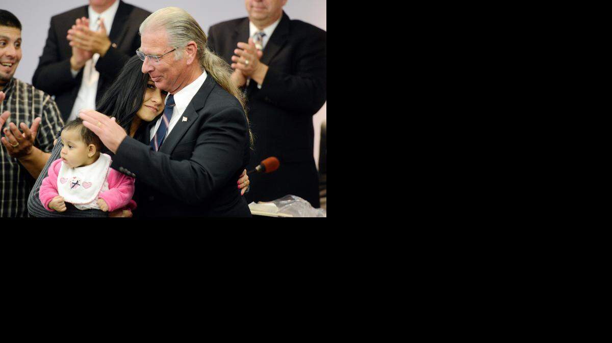 
Atwater Mayor Jim Price hugs his daughter, Jacqueline Moreno, and pats the head of his great-granddaughter, 6-month-old Aras, after being sworn in during a City Council meeting on Monday.
