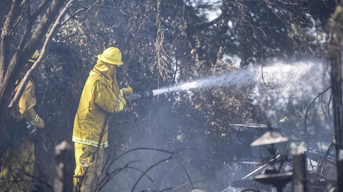 One woman suffered serious burns on her arm and a building was gutted Friday in a fire that still is burning, Merced County Sheriff Vern Warnke confirmed to the Sun-Star.