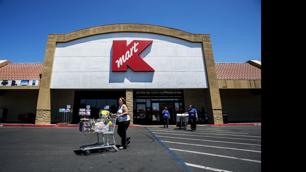 
Customers leave the Kmart store on Bellevue Road in Atwater on Tuesday. The store will be closing its doors in October.
