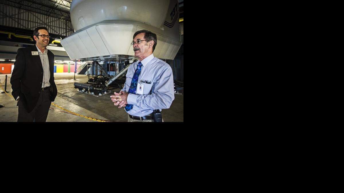 
Sierra Flight Academy device manager Dave Marcum, right, speaks with Merced County District 3 Supervisor Daron McDaniel prior to a demonstration Tuesday of the academy’s 11-ton Boeing 737 flight simulator at Castle Commerce Center in Atwater. 
