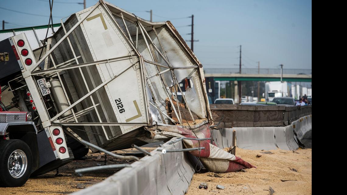 
The California Highway Patrol and the California Department of Transportation work to clean up the scene of a tractor-trailer crash on Highway 99 just south of North Buhach Road in Atwater, Calif., on Wednesday, May 20, 2015. According to CHP Officer Moises Onsurez, the tractor-trailer was carrying two grain trailers heading north on Highway 99 when it crossed into the southbound lanes and overturned, spilling grain across both sides of the highway. Both southbound lanes of Highway 99 and the left northbound lane of Highway 99 were closed. The driver of the truck suffered major injuries and was transported to Doctors Medical Center in Modesto.
