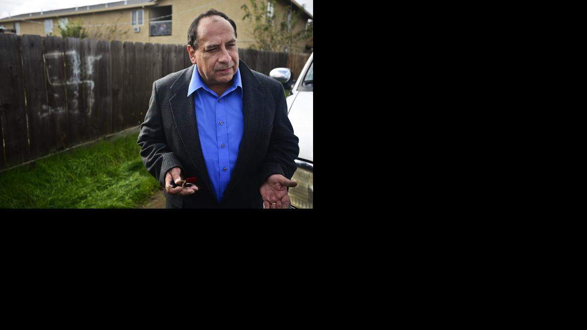 
Atwater resident Fernando Echevarria, 52, speaks about a swastika painted on a fence in an alleyway behind the 1800 block of Olive Avenue in Atwater on Wednesday. The swastikas began appearing in the city two weeks ago. 
