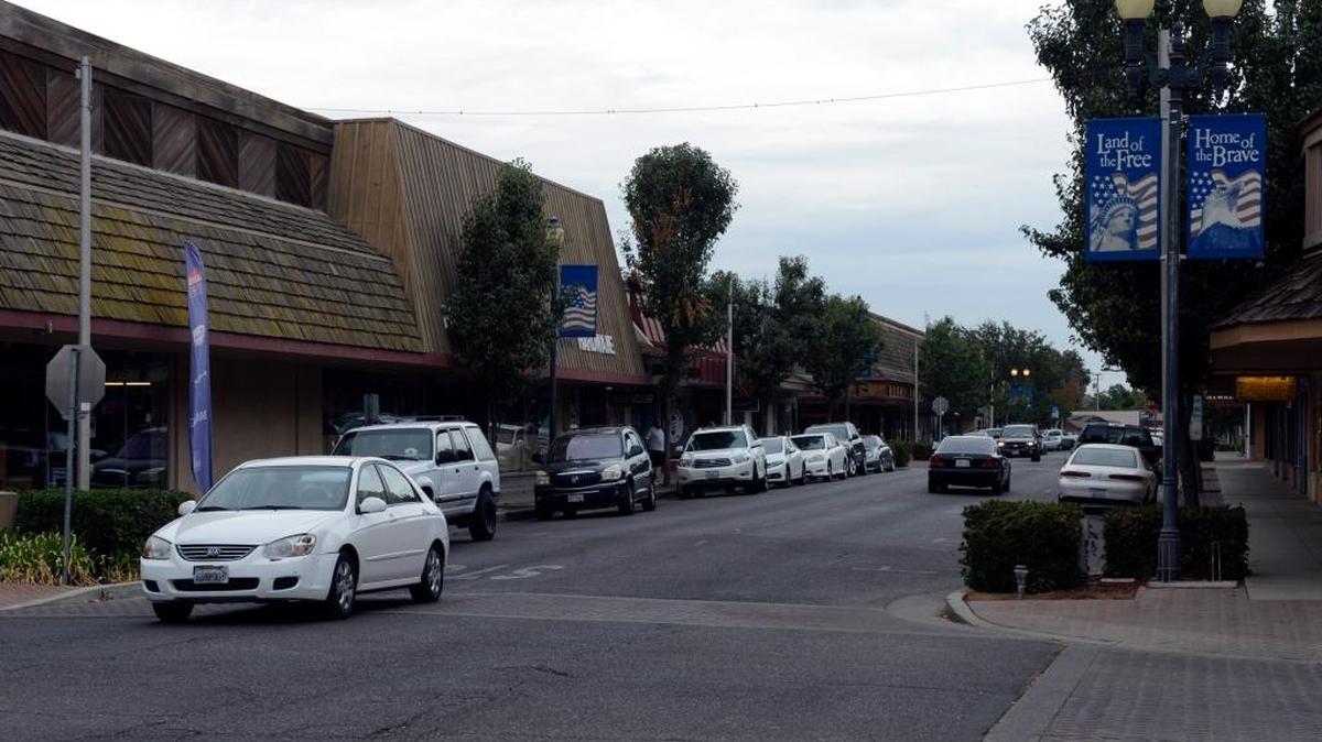 
A car heads down Broadway Avenue in downtown Atwater on Wednesday, Sept. 30, 2015. Some business owners have complained that homeless people hang out downtown, leaving a mess for them to clean up.
