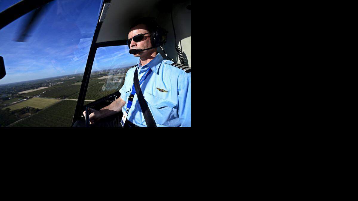 
Helicopter pilot and Sierra Academy of Aeronautics flight instructor Joe Newman flies over Atwater in a Robinson R22 helicopter after taking off from Castle Airport on Friday.
