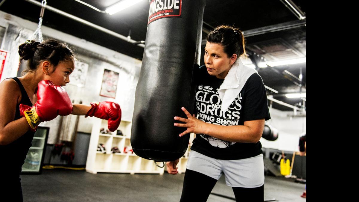 
Liza Lopez, 34, of Livingston trains Amber Galvan, 9, of Ballico at the 51 Fifty Boxing Club in Livingston on Friday. Lopez, a former boxer, is a medical assistant at Merced Faculty Associates Medical Group and trains boxers at the Livingston gym.
