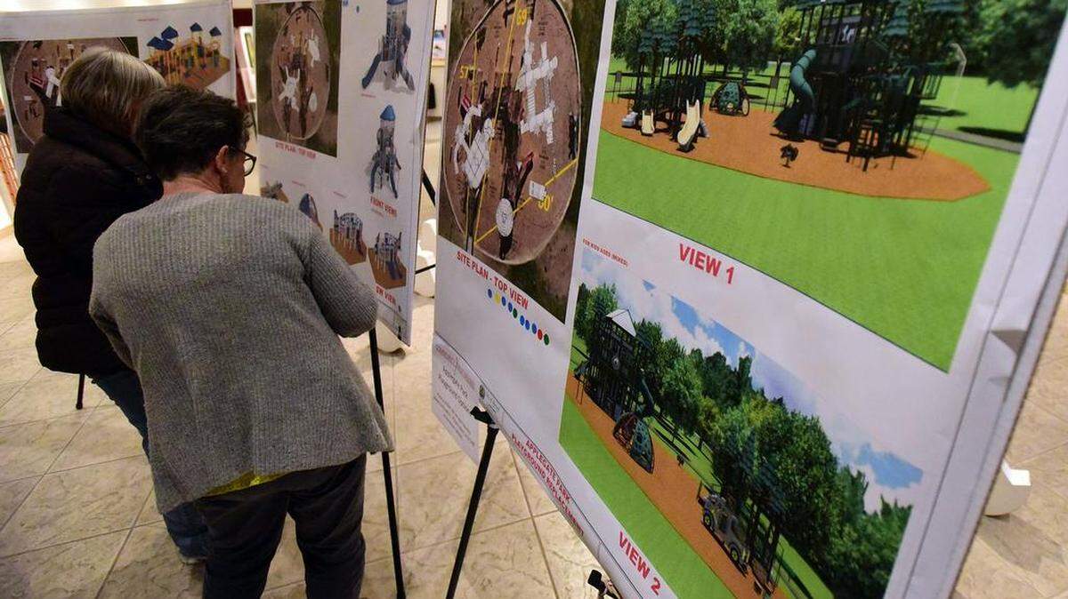 Women check out possible plans on Tuesday, Feb. 13, 2018, for the play structure at Applegate Park, which was recently torn down for safety concerns. The city of Merced is asking residents to vote on their favorite at town hall-style meeting s this month.