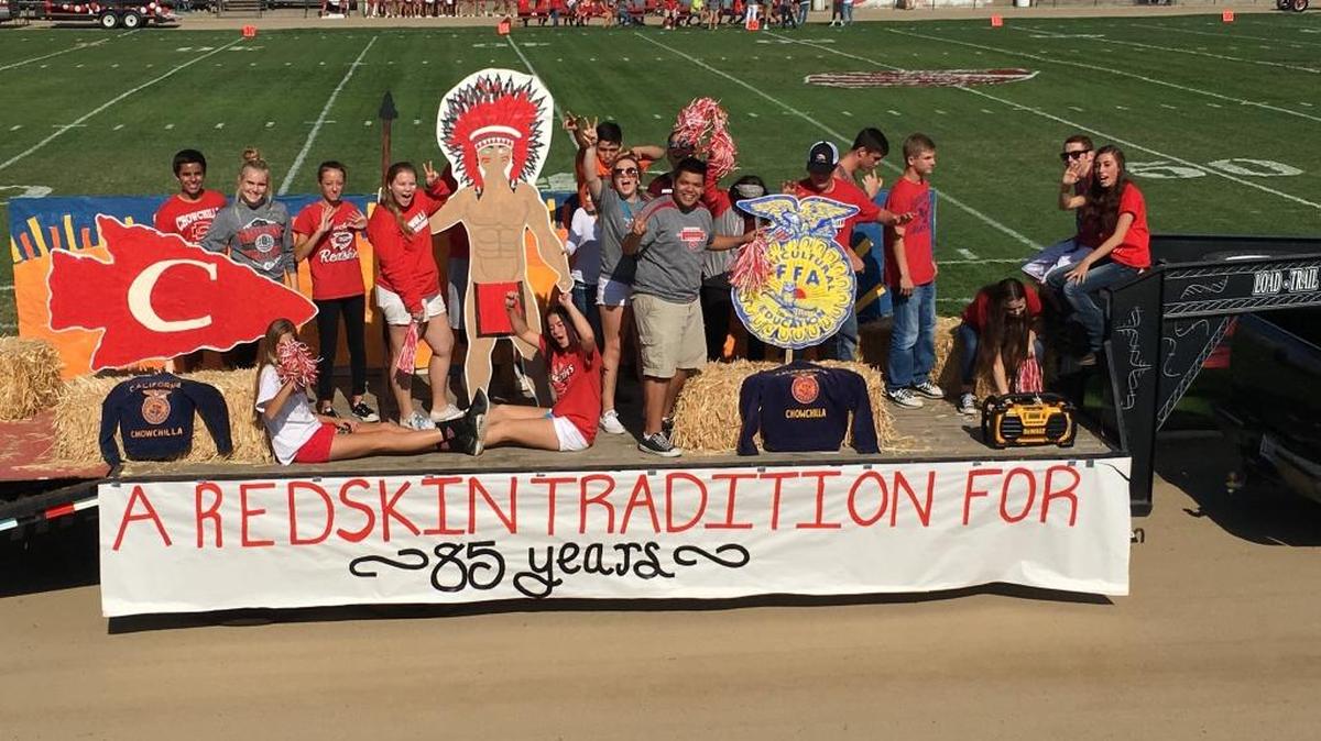 Chowchilla High School students ride a float with the school’s mascot, which must be phased out by 2017.