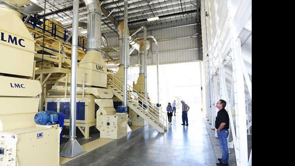 
Derek Wood, of Beeler Industries, far right, gives a tour of the beginning stage of a hulling and shelling processor at Minturn Huller Cooperative in Chowchilla last year. The city recently implemented a plan to try to attract more industry. 
