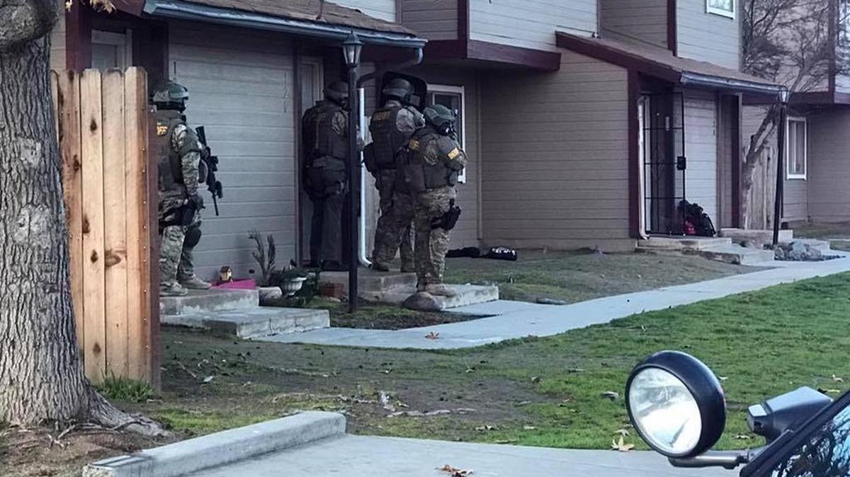 The multiagency Madera County Special Weapons and Tactics unit responds to a standoff in Chowchilla on Friday.