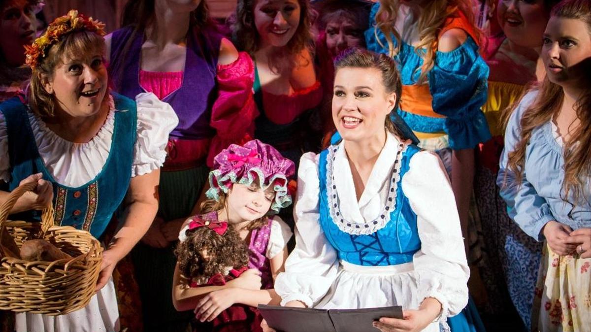 Belle, played by Rachel Pearre, is surrounded by townspeople during a dress rehearsal of Disney’s “Beauty and the Beast” at Playhouse Merced, which premieres at 7:30 p.m. Friday, Nov. 18.