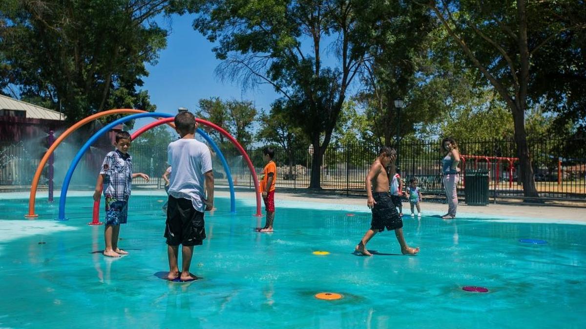 Children cool off in the Stephen Leonard Park splash pad in Merced, Calif., Saturday, June 25, 2016.