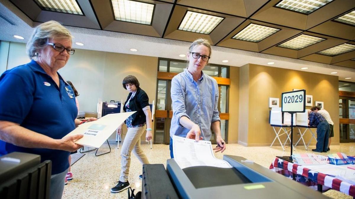 Merced resident Brandi McKuin, 43, turns in her ballot at the Merced County Administration Building located at 2222 M Street in Merced, Calif., Tuesday, June 7, 2016, during the state primary.