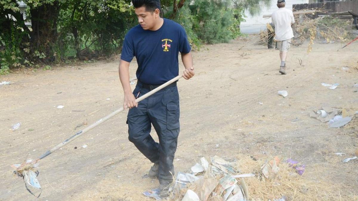 Edgar Tovar , 20, and several others clean up a vacant lot in south Merced on Saturday, Sept. 13, 2014. A clean-up event organized by Golden Valley Health Center is 9 to 11 a.m. Saturday.