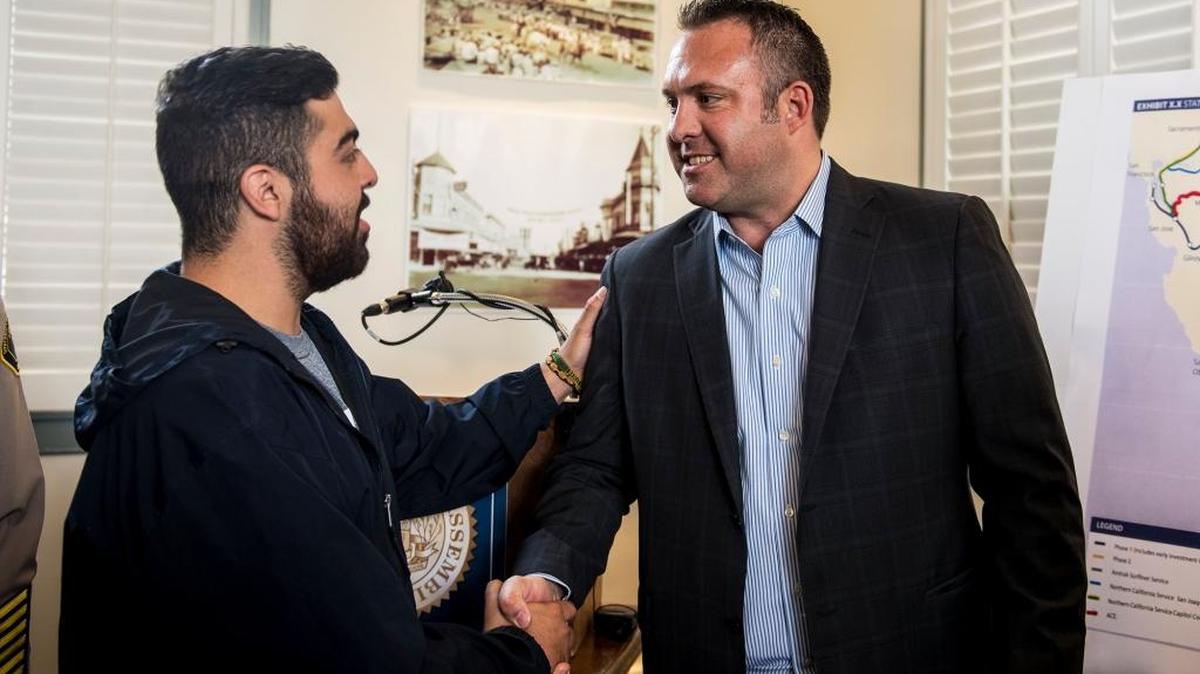University of California, Merced senior and President of I Will Ride, Isaias Rumayor III, 21, of Turlock, left, shakes hands Assemblyman Adam Gray, D-Merced, right, following a news conference announcing plans to include Merced along the High-speed rail at Gray's office in Merced, Calif., Friday, April 22, 2016.