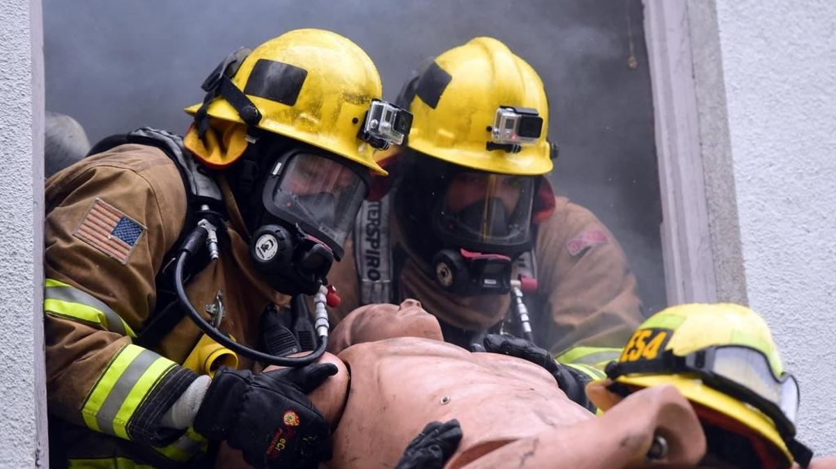 Nathaniel Lee, left, and Josh Gehring, Merced’s newest firefighters, train with a dummy inside the former Rescue Mission on Canal Street on Friday, March 24, 2017.