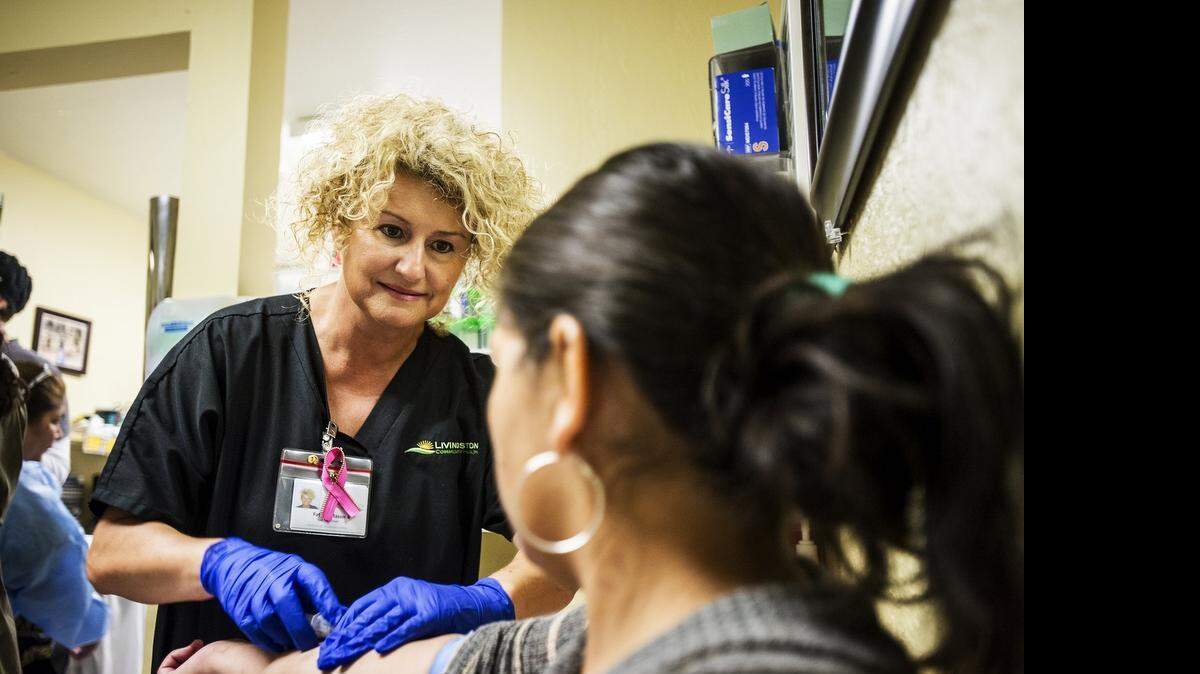 
Phlebotomist Fatima Mason draws blood from a patient during the spring fair at Livingston Community Health in Livingston, Calif., Saturday, April 25, 2015. Community resources as well as free health screenings were available for residents during the event.
