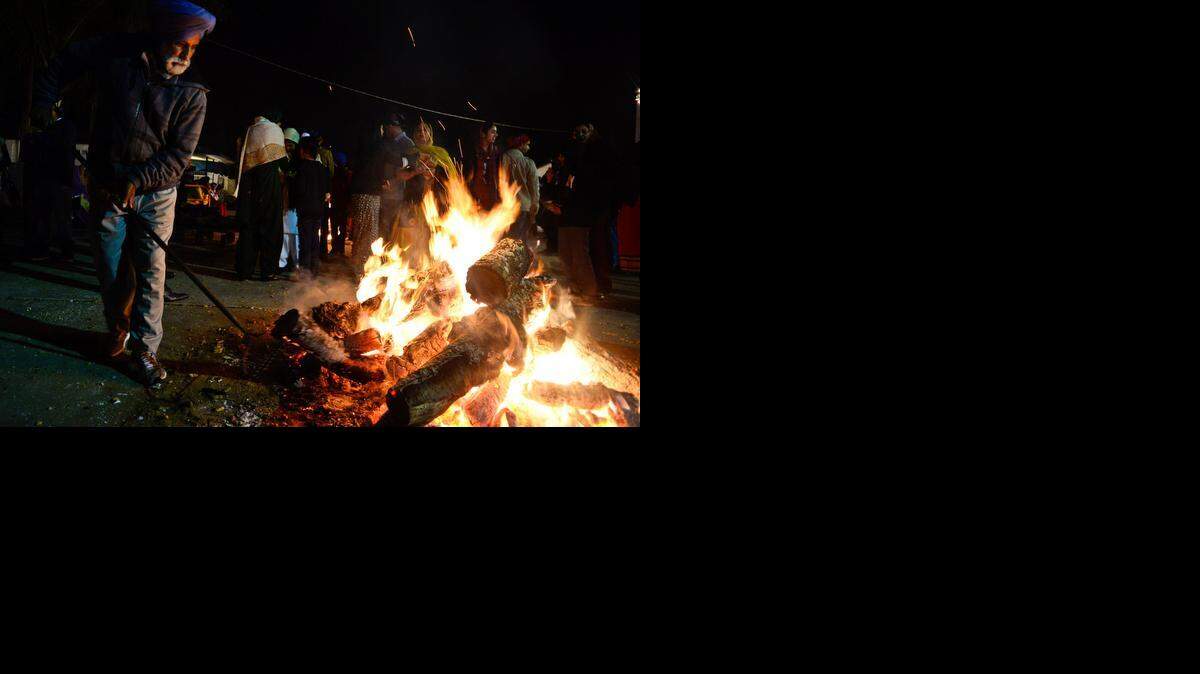 
Nirmal Singh, 74, of Livingston tends the fire during Lohri, a Punjabi festival, in Livingston on Tuesday.
