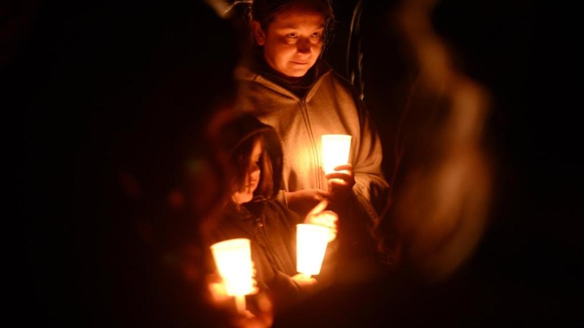Mourners gather on Walnut Avenue near Sultana Drive in Livingston on the one-year anniversary of the hit-and-run death of 16-year-old Raymond Martinez on Monday, March 27, 2017.
