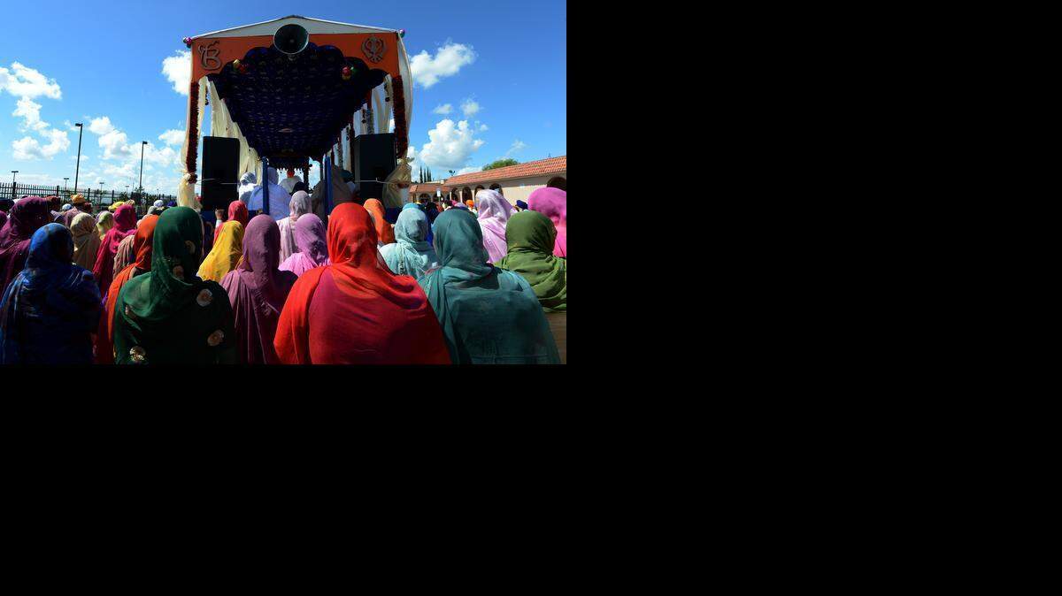 
Hundreds of Sikhs march alongside the float bearing Guru Granth Sahib on Peach Avenue during last year’s parade in Livingston. 
