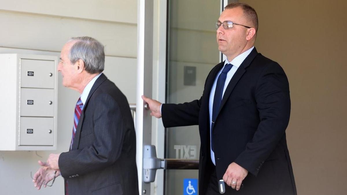 Officer Tyson Perry, 38, right, leaves the Merced County Superior Courthouse with attorney William Rapoport during a lunch break on Wednesday, June 22, 2016.
