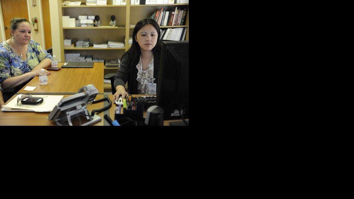 
Covered California enrollment counselor and Healthy House administrative assistant Nai Saechao, right,  helps Sheila Herb of Merced with her application for health insurance at Healthy House in Merced in 2014. 
