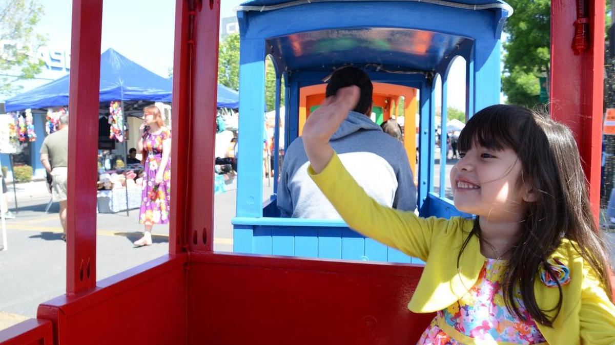 Samantha Reyes, 4, of Los Banos rides in the Knights Express train in 2014 at the Downtown Spring Street Faire. Above, girls play with bubbles at last year’s Spring Street Faire.