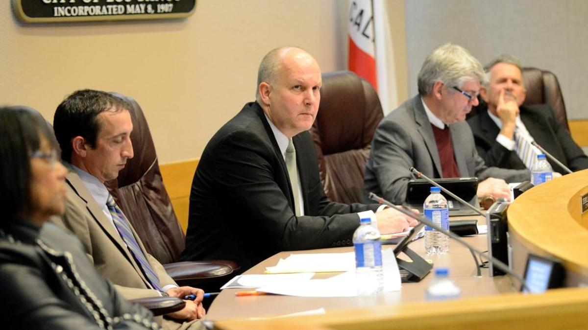 Los Banos City Manager Steve Carrigan, center, watches Wednesday, Jan. 6, 2016, as the City Council listens to a presentation about the effects marijuana cultivation has on the city. Police Chief Gary Brizzee urged the council to adopt an outright ban on sales and cultivation.