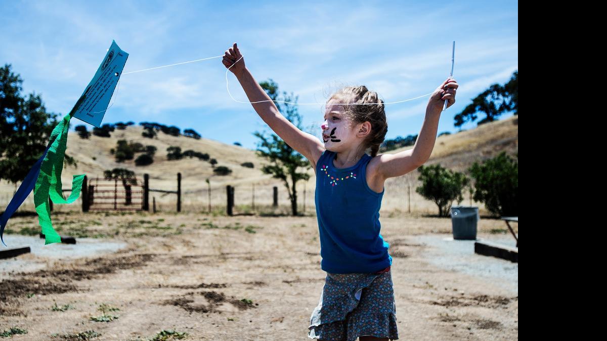 
Charlotte Aeschleman, 5, of Hollister tries out a kite she built during Family Kite Day at Pacheco State Park on Saturday. The event offered face painting, kite building, a bubble-gum-blowing competition and a pie-eating contest.
