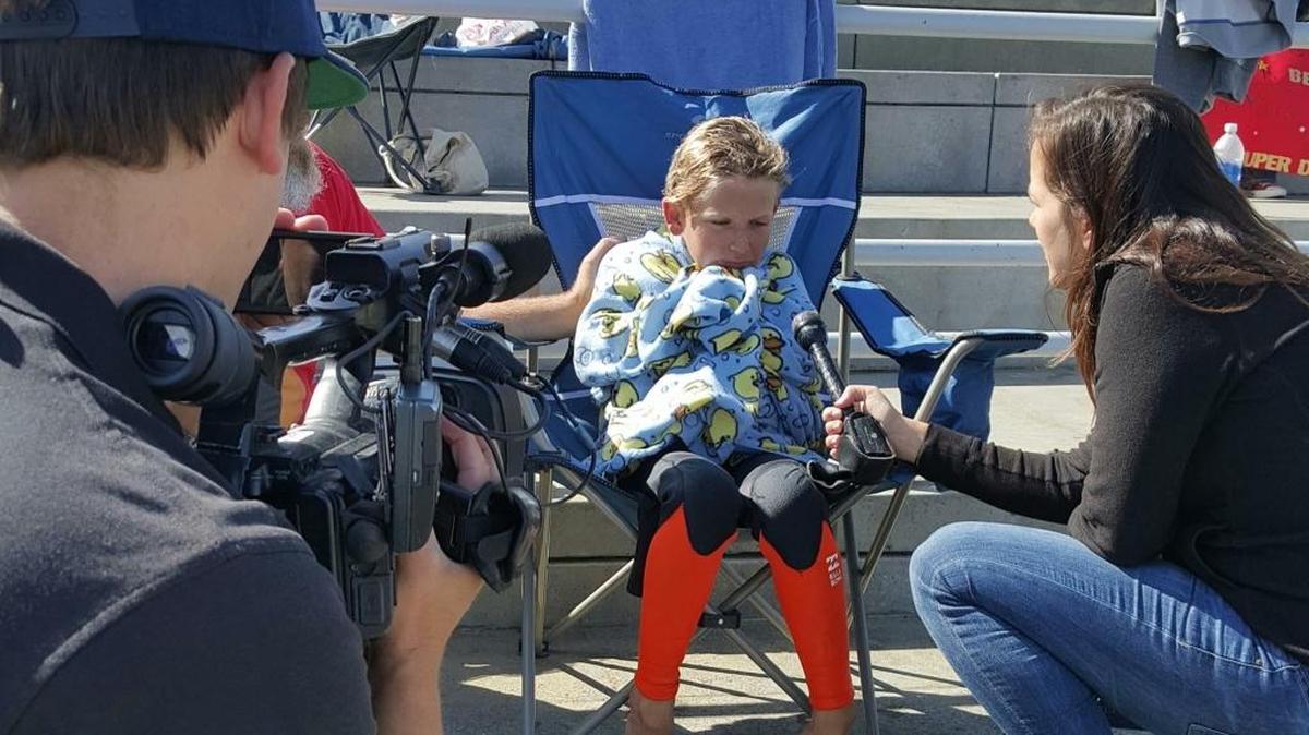 Mercey Springs Elementary student James Savage fields questions from reporters after the 9-year-old Los Banos boy swam from the San Francisco Aquatic Park to Alcatraz and back Tuesday morning.