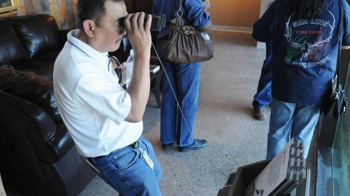 Louie Asuncion of Sacramento, who works for the Fish and Wildlife realty division, uses binoculars to look for birds and tule elk during the first tours given in 2011 at the San Luis National Wildlife Refuge headquarters and visitors center just outside of Los Banos.