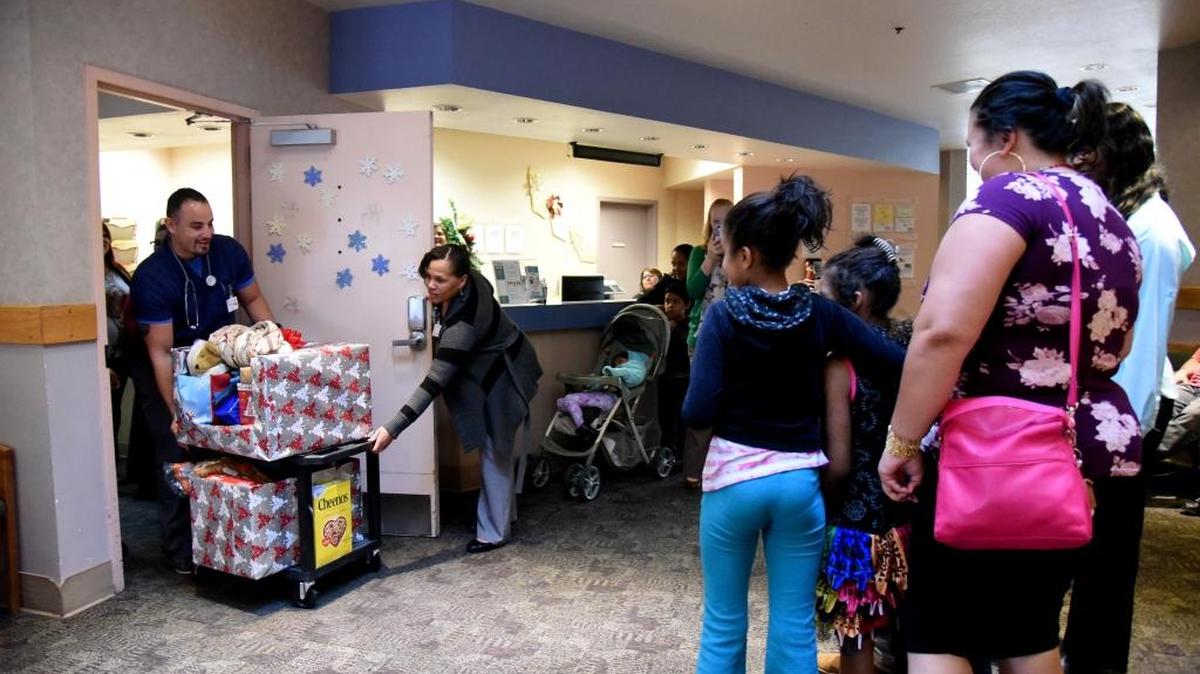 Staff at Golden Valley Health Centers surprise Rosio High and her four children with Christmas presents on Wednesday, Dec. 23.