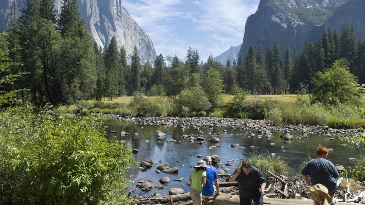 
Visitors explore near the Merced River at Yosemite National Park on Tuesday. On Tuesday, the state health department announced an investigation of a “presumptive positive case of plague” involving a person from Georgia who visited the park and the Sierra National Forest earlier this month.
