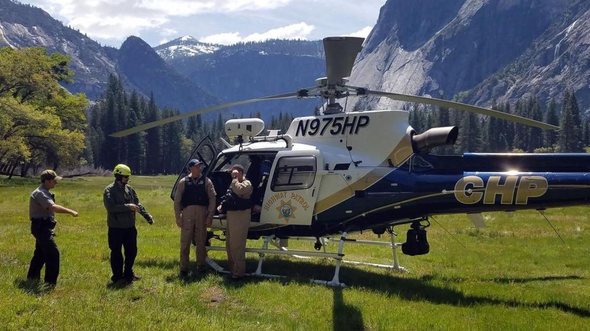 Yosemite National Park rangers prepare to depart in a California Highway Patrol helicopter from Ahwahnee Meadow in Yosemite Valley while searching for a missing park visitor on Monday, May 8, 2017. Park Rangers, search dogs and the helicopter are searching trails in and above Yosemite Valley trying to located Alexander Sevier.