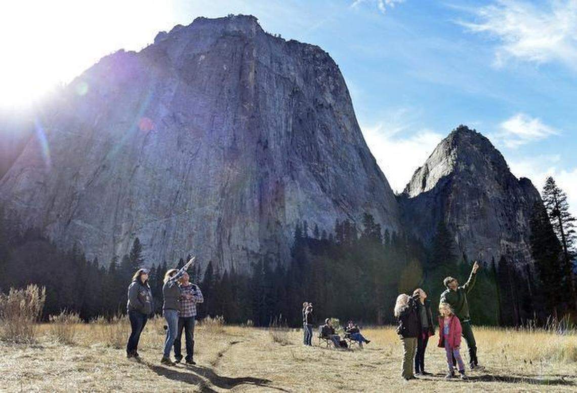 Curious onlookers gather in El Capitan Meadow in Yosemite National Park to see the progress of climbers Kevin Jorgeson and Tommy Caldwell up the Dawn Wall of El Capitan earlier in January 2015.