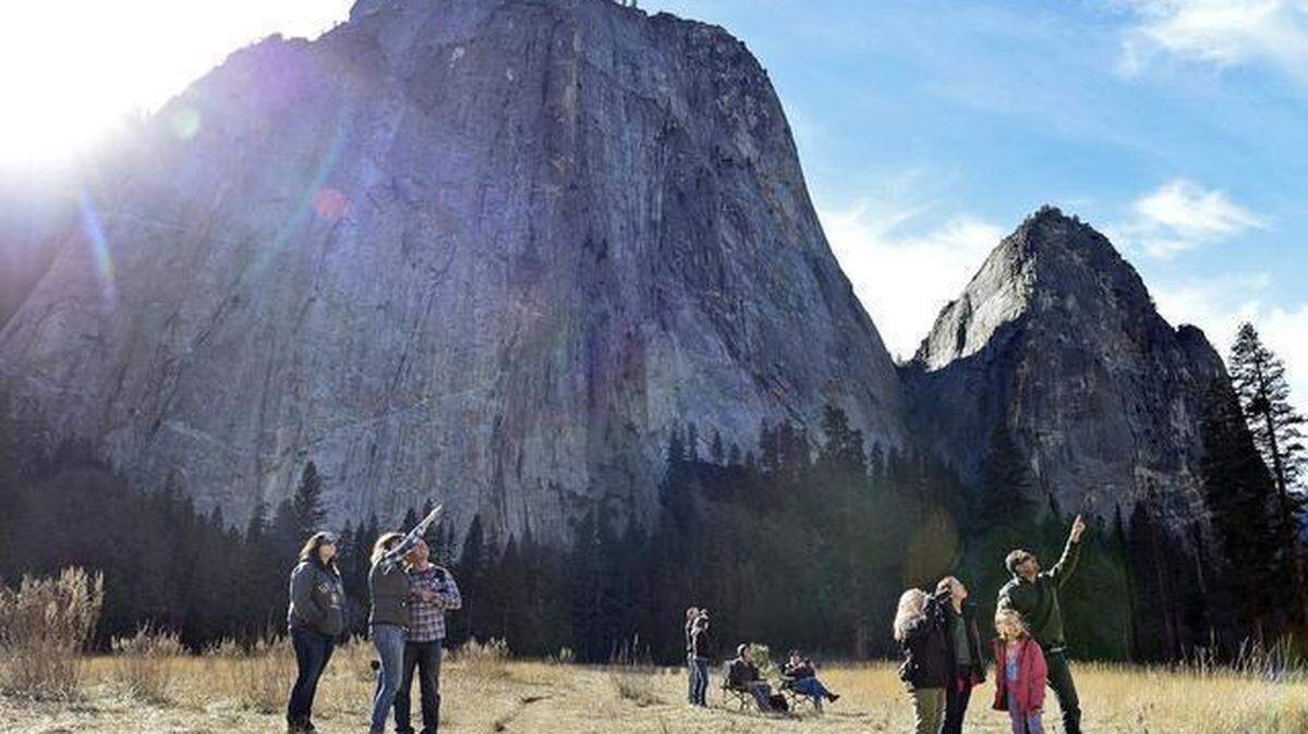 Curious onlookers gather in El Capitan Meadow in Yosemite National Park to see the progress of climbers Kevin Jorgeson and Tommy Caldwell up the Dawn Wall of El Capitan earlier in January 2015.