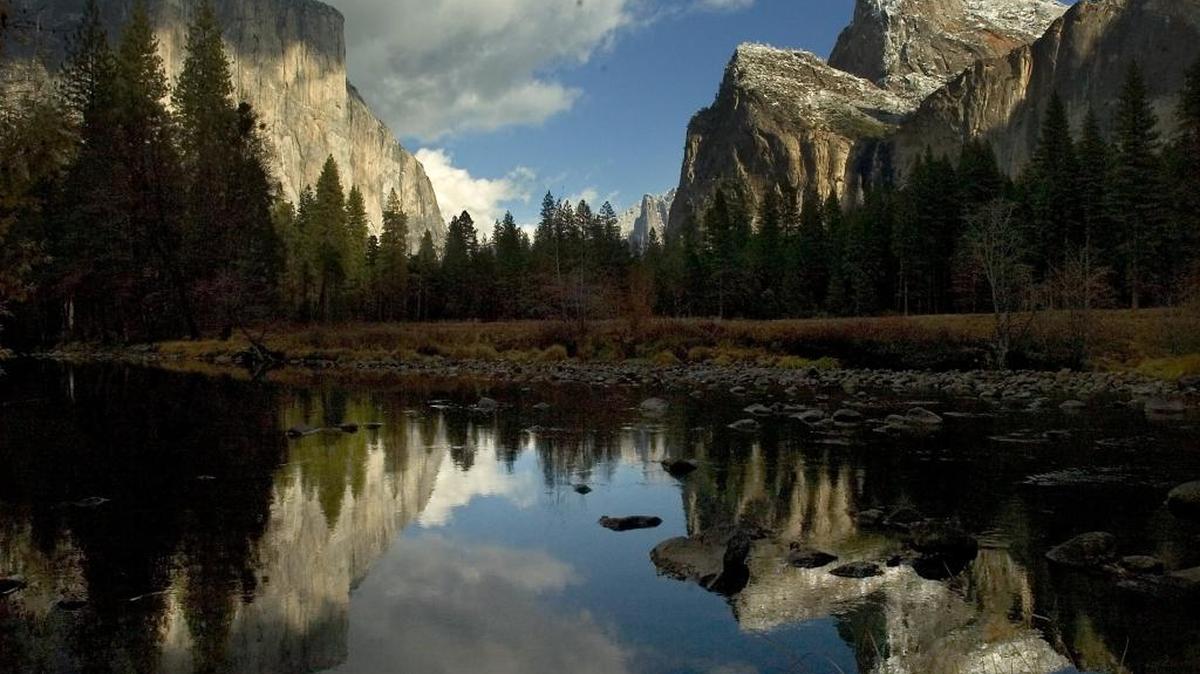 
Yosemite National Park and Google Maps announced their partnership on a project that allows visitors to explore the park’s features with the help of “cutting-edge technology.” Here, El Capitan, left, and the Cathedral Rocks, right, are reflected in the Merced River in Yosemite National Park in late November light.
