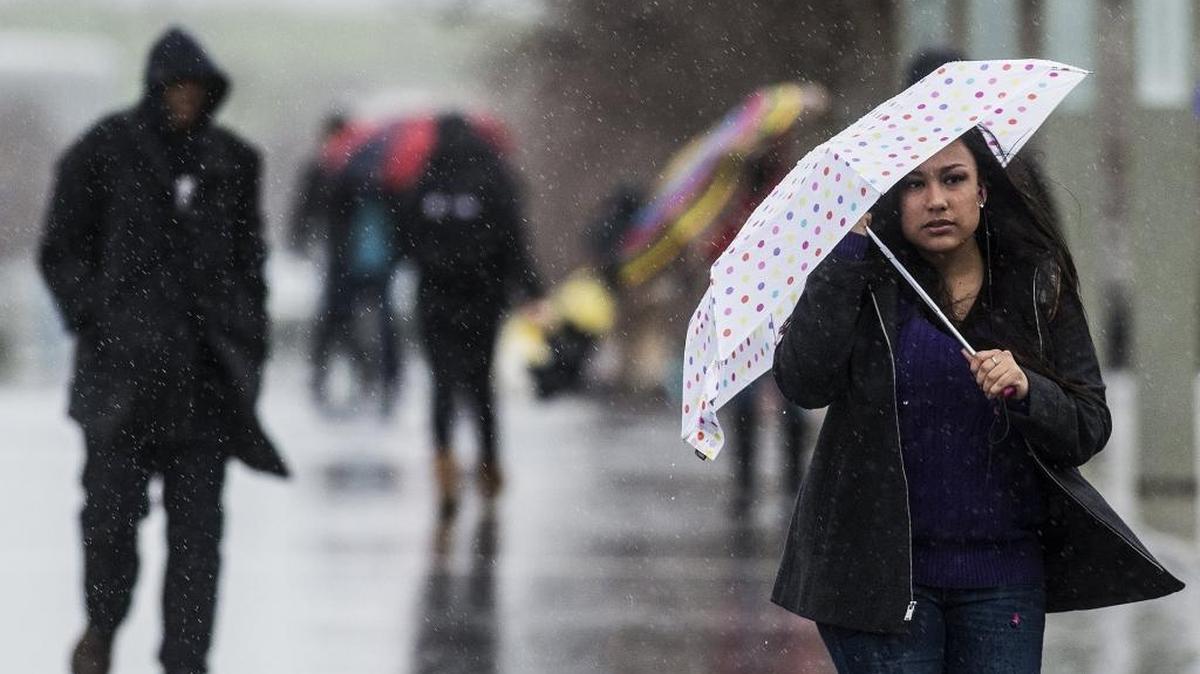 University of California, Merced freshman Audrey Lara, 18, shields herself from the blowing rain with her umbrella as rain and wind blow through Merced in January.