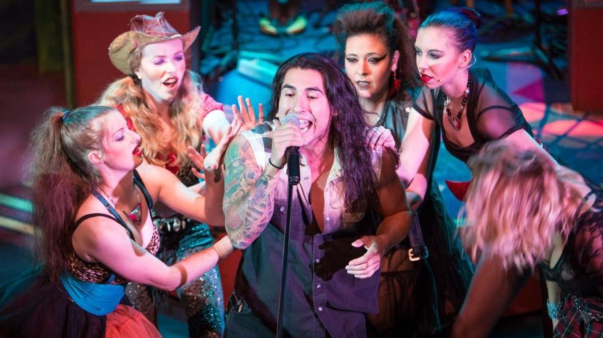 Matt Cantu and others in the cast from “Rock of Ages” perform 1980s rock hits at Playhouse Merced during a recent rehearsal. The show premieres 7:30 p.m. Friday, Sept. 2, at the 452 W. Main St. playhouse.