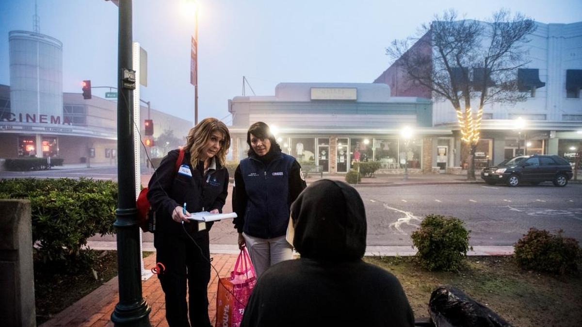 Riggs Ambulance Service Operations Supervisor Kelly Kinkade, left, and Community Relations Manager Sonya Severo, right, speak with a homeless man along Main Street during the Merced County Continuum of Care Homeless Count in Merced on Jan. 28, 2016. This year’s count is set for Thursday.