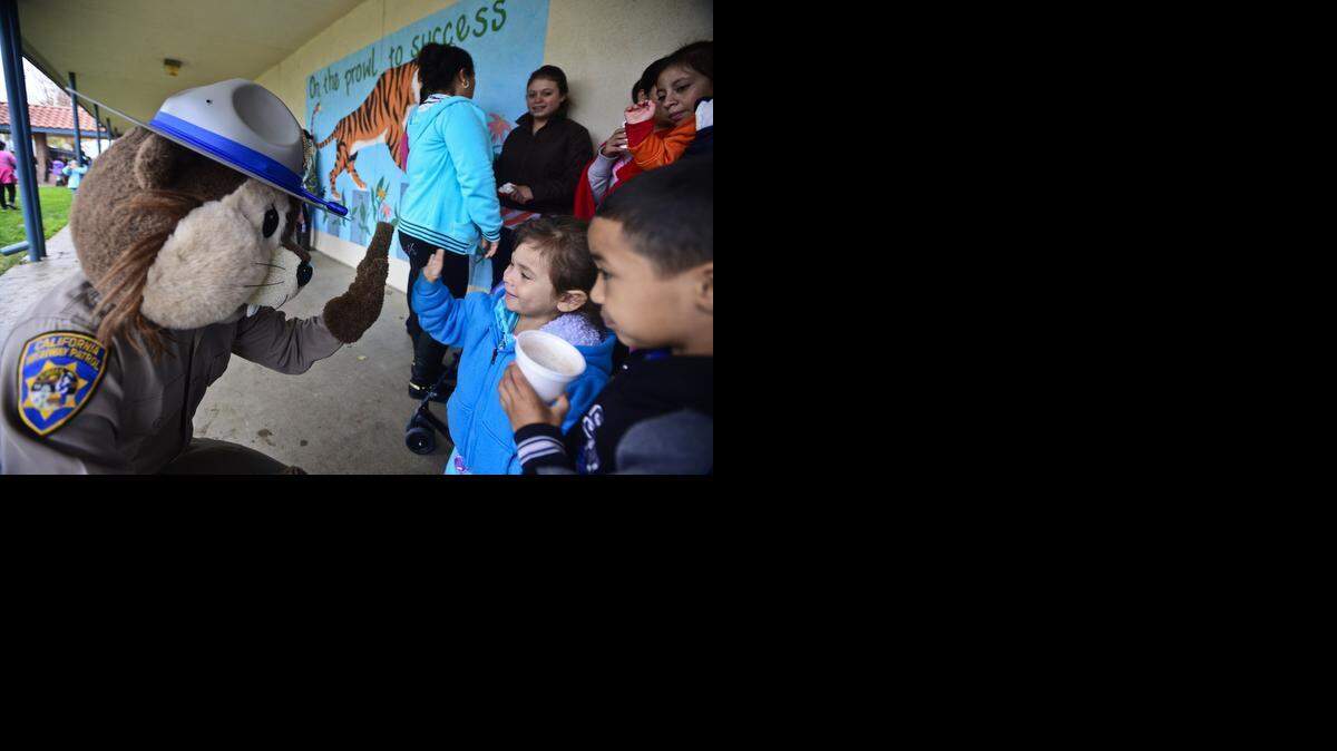 
Marisol Cristian Rojas, 4, of Planada, high-fives California Highway Patrol mascot Chipper at Planada’s Christmas party at Planada Elementary School on Saturday. The event, which is organized by the Planada Christmas Cherished Memories Group and the California Highway Patrol, is made possible through donations from local businesses and nonprofit organizations.
