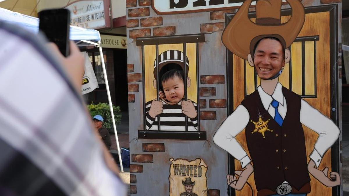 Dad James Vang, right, poses for a picture with son Parker Vang, both of Merced, during the Cap & Town in Merced, Calif., on May 16, 2014, the last time the event was held.