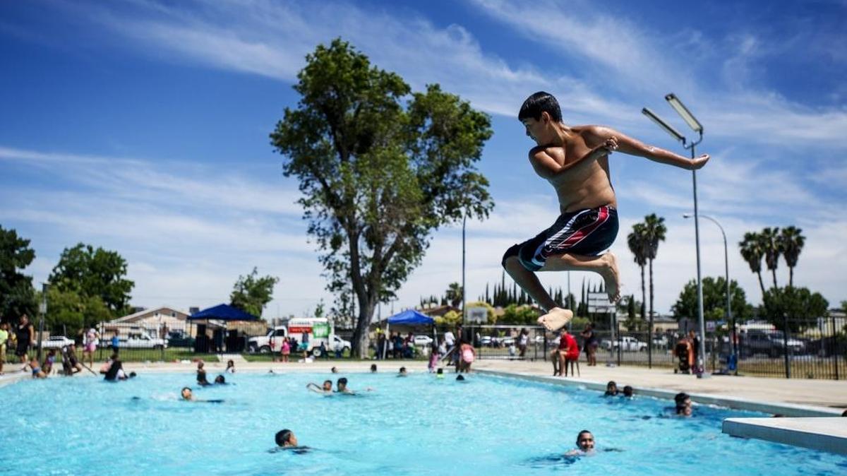 Anthony Granados, 13, of Merced jumps off the diving board at the McNamara Park pool in Merced, Calif., on Thursday, June 9, 2016.