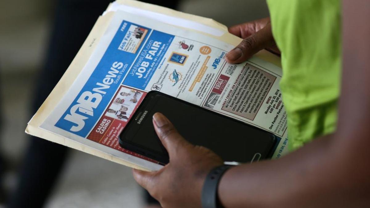 In this Tuesday, July 19, 2016, file photo, a job applicant attends a job fair in Miami Lakes, Fla.