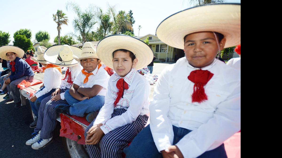 Boys from Grupo Folklórico  Juan Colorado of Planada Elementary ride a trailer as they ready for the 2014 Planada Community Day parade.