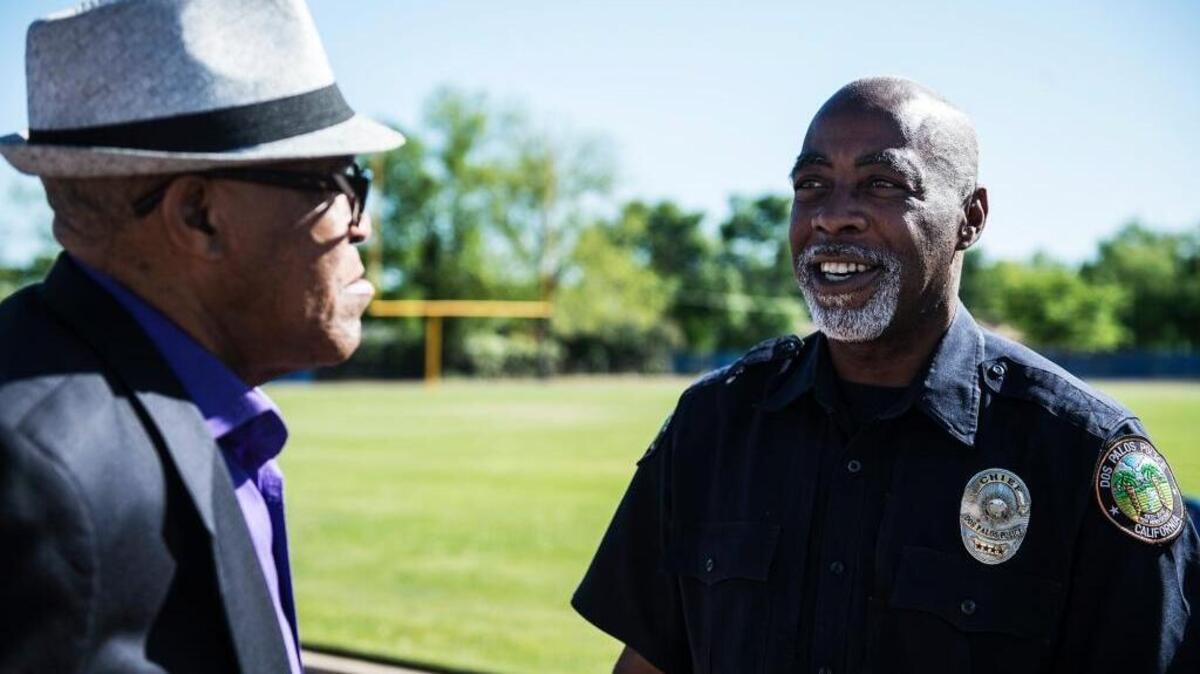 Dos Palos Police Chief Barry Mann, right, before speaking with his cousin and Olympic gold medal winner Lee Evans, 68, of Castro Valley at Dos Palos High School in Dos Palos, Calif., Monday, April 13, 2015.
