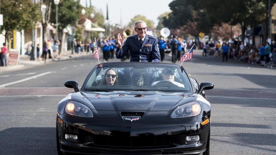 Grand Marshal Chuck B. Fennessy, 87, waves to the crowd during the 2016 Merced Veterans Day Parade in downtown Merced on Friday.